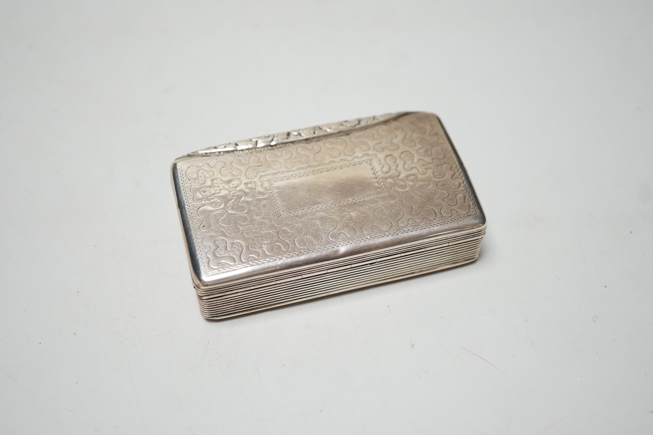 A late George IV engraved silver rectangular snuff box, with wriggle work decoration, William Simpson, Birmingham, 1829, 81mm.